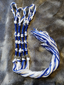 Royal blue and white tzitzyot with silver-colored beads