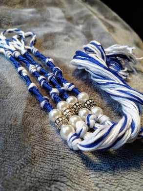 Royal blue and white tzitzyot with white pearls and silver-colored beads